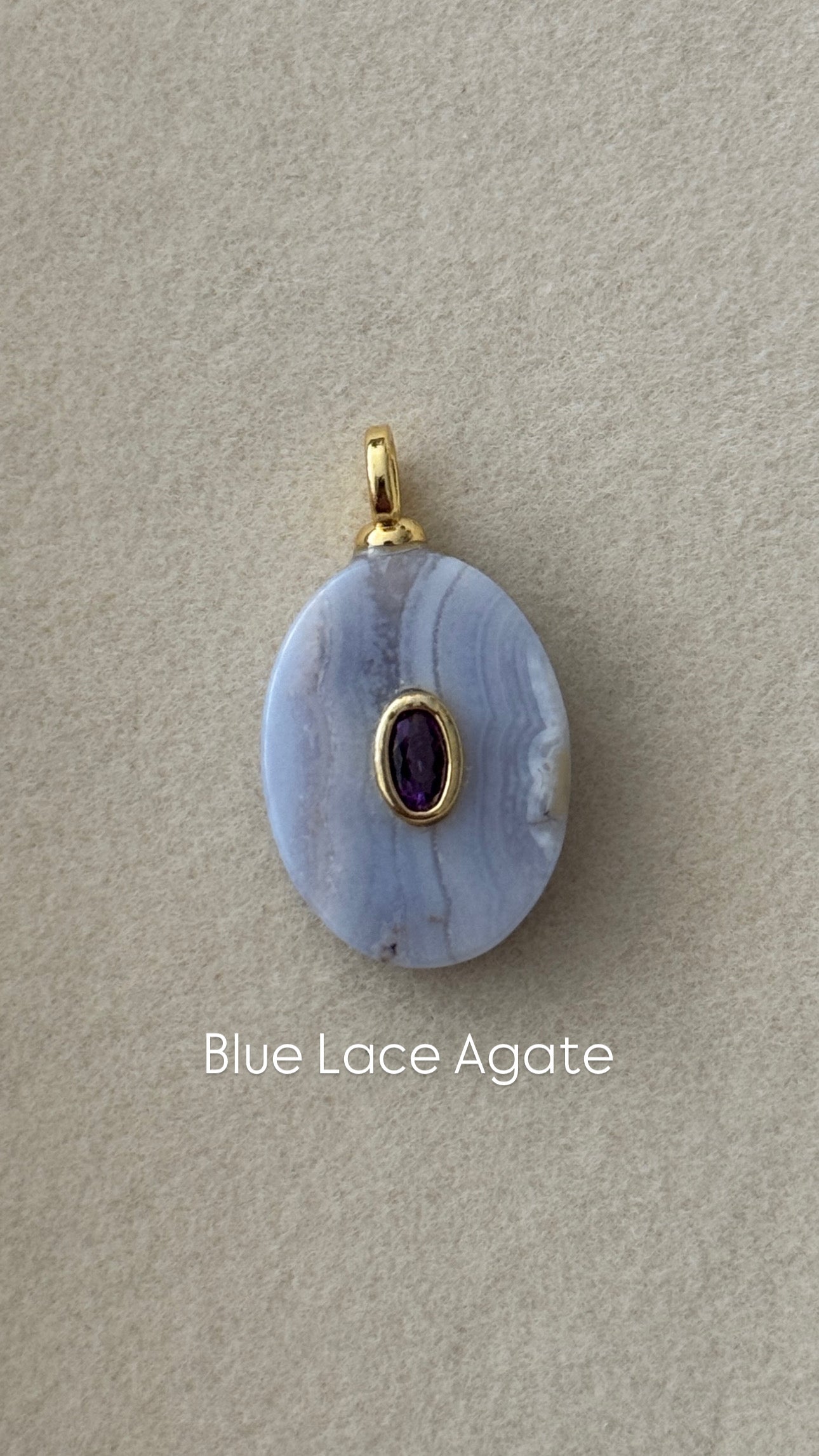 Blue lace agate pendant with gold accent on a beige background