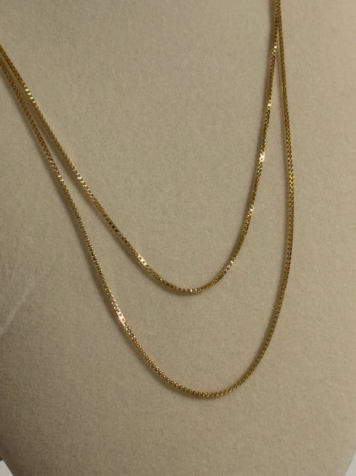 Gold chain on a beige background